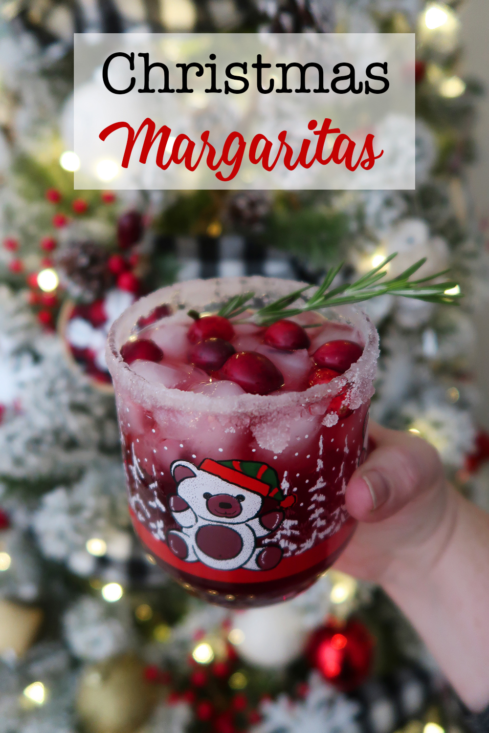 Christmas Margarita in a vintage teddy bear glass rimmed with sugar and topped with cranberries and a sprig of rosemary.